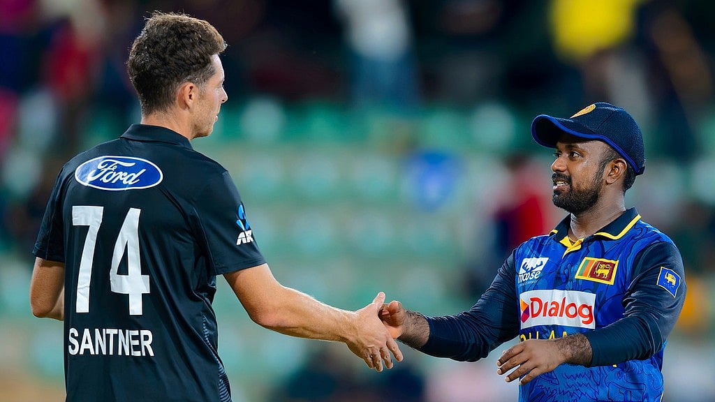 AP/Viraj Kothalawala : New Zealand's captain Mitchell Santner, left, congratulates Sri Lanka's captain Charith Asalanka for winning the first ODI in Dambulla.
