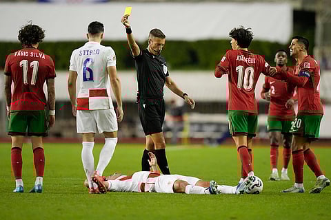 Nations League Soccer: Portugal's Fabio SIlva sees the yellow card after a foul
