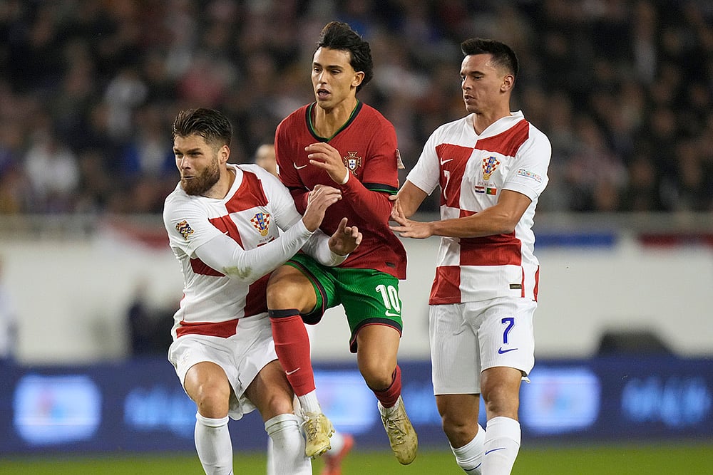 | Photo: AP/Darko Bandic : Nations League Soccer: Portugal's Joao Felix challenges for the ball 