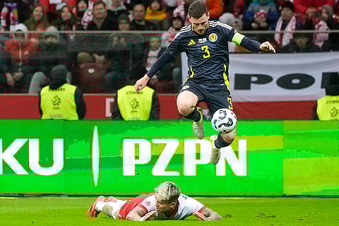 Nations League Soccer: Scotland's Andy Robertson controls the ball as he jumps over Poland's Kamil Piatkowski