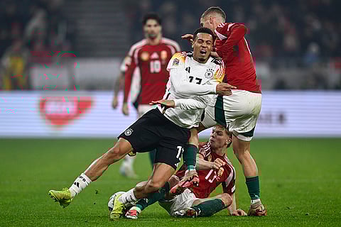 Nations League Soccer: Germany's Felix Nmecha is challenged by Hungary's Marton Dardai, right, and Hungary's Andras Schafer