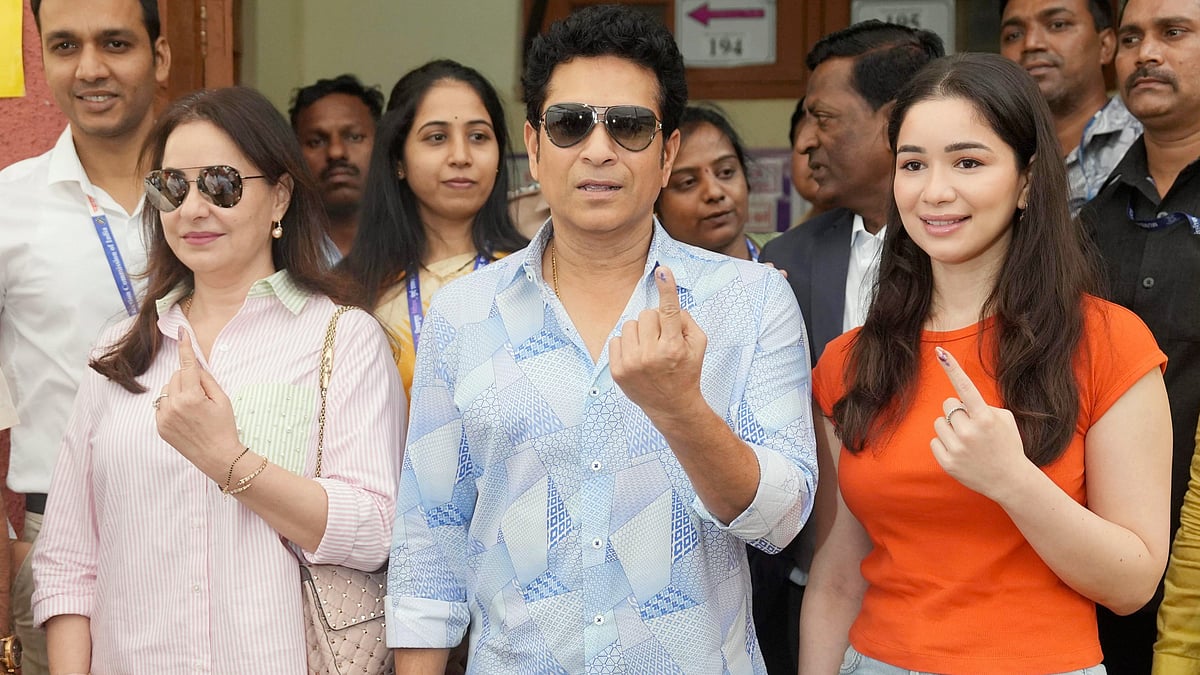 PTI : Former cricketer Sachin Tendulkar, wife Anjali and daughter Sara show their fingers marked with indelible ink after casting votes at a polling station.