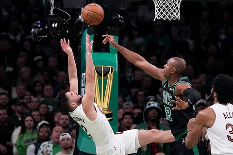 NBA Basketball: Cavaliers guard Ty Jerome, left, tries to put up a shot against Celtics center Al Horford