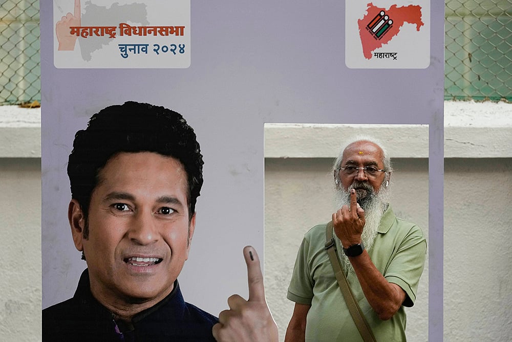 | Photo: AP/Rajanish Kakade : Maha Assembly polls: Senior citizen Amol Prabhu shows his index finger