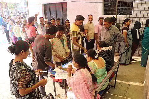 Maha Assembly polls: People wait in a queue at a polling station in Nagpur