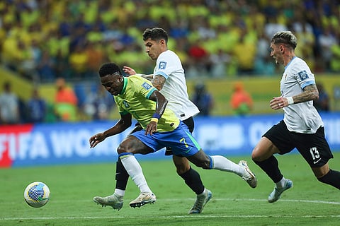 Football World Cup 2026 Qualifiers: Brazil's Vinicius Junior, left, and Uruguay's Mathias Olivera battle for the ball