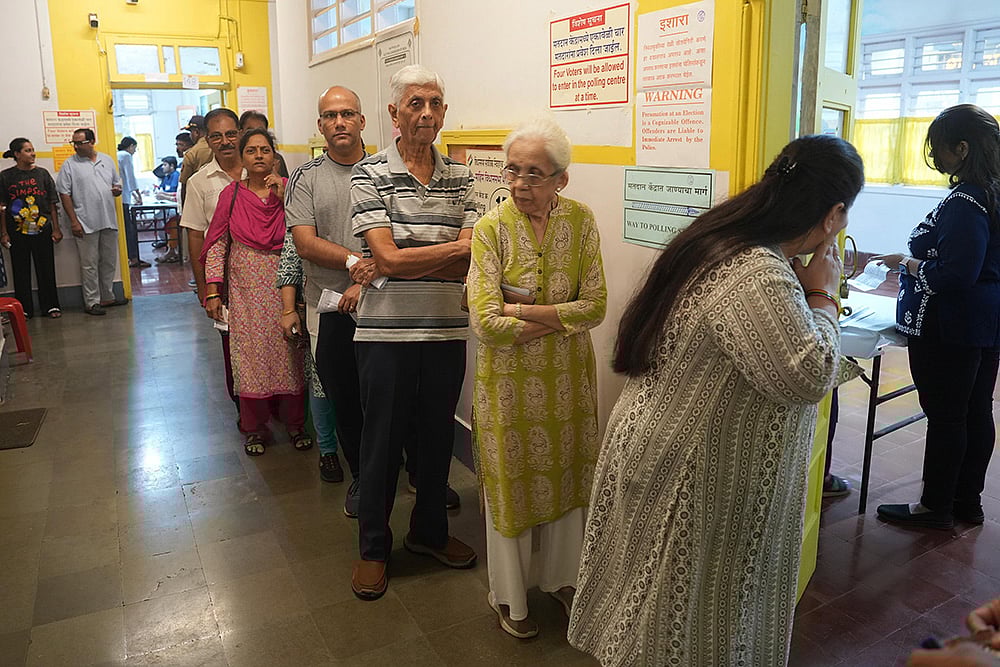 | Photo: PTI/Kunal Patil : Maha Assembly polls: Voters wait in a queue to cast their votes in Dadar