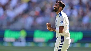 | Photo: AP/Trevor Collens : IND Vs AUS 1st Test, Day 1: India's captain Jasprit Bumrah gestures as he prepares to bowl