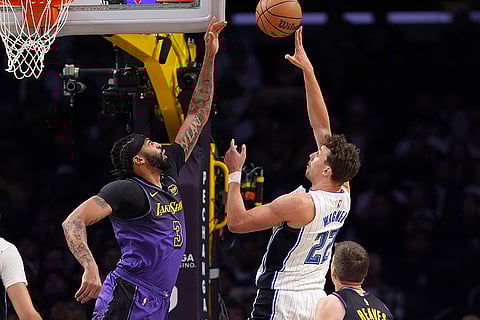 NBA: Magic forward Franz Wagner, right, shoots as Lakers forward Anthony Davis defends