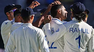 AP/Trevor Collens : Harshit Rana, third right, is congratulated by teammates after taking the wicket of Travis Head on the first day of the first Test between Australia and India in Perth.