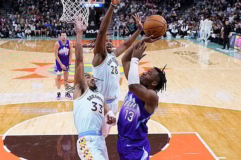 NBA: Jazz guard Isaiah Collier (13) drives to the basket against Spurs guard Tre Jones (33)