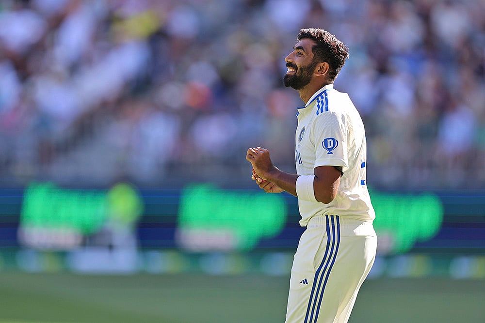 | Photo: AP/Trevor Collens : IND Vs AUS 1st Test, Day 1: India's captain Jasprit Bumrah gestures as he prepares to bowl