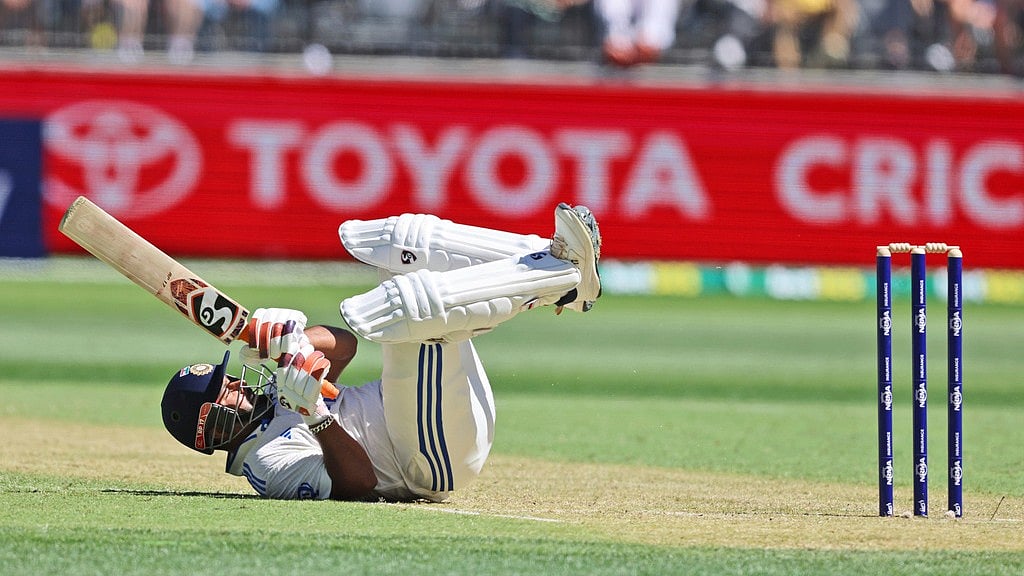 Rishabh Pant loses his balance after hitting Pat Cummis for a six during the first Test between India and Australia in Perth. - AP/Trevor Collens