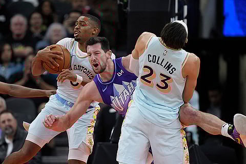 NBA: Jazz forward Drew Eubanks, center, battles Spurs forward Keldon Johnson (0) and forward Zach Collins (23) for a rebound