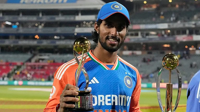 India's Tilak Varma poses with the Player of the Match and Player of the Series trophies - | Photo: AP/Themba Hadebe
