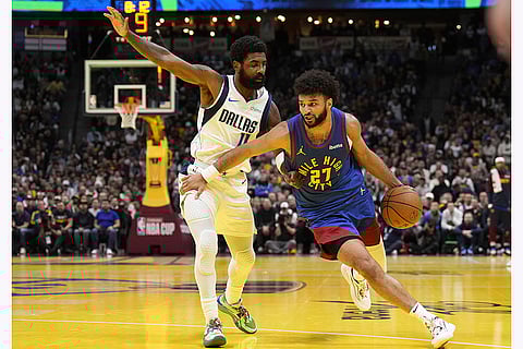 NBA 2024-25: Nuggets guard Jamal Murray (27) drives to the basket against Mavericks guard Kyrie Irving (11)