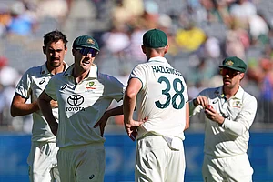 | Photo: AP/Trevor Collens : IND Vs AUS 1st Test, Day 2: Australia's captain Pat Cummins, second left, has a chat with teammate Josh Hazlewood