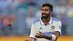 AP Photo/Trevor Collens : India's captain Jasprit Bumrah collects the ball as he prepares to bowl on the first day of the first cricket test between Australia and India in Perth.