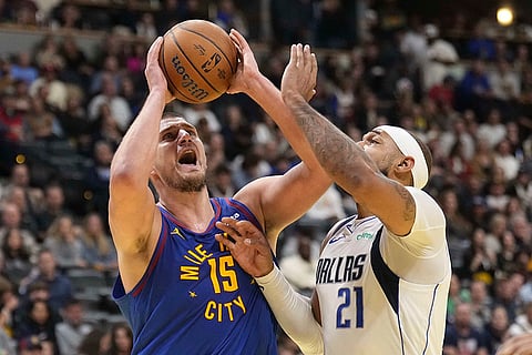 NBA 2024-25: Nuggets center Nikola Jokic (15) is pressured by Dallas Mavericks center Daniel Gafford (21)