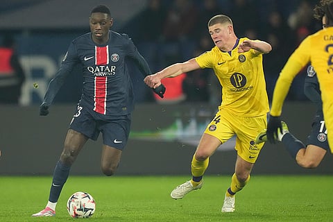 Ligue 1: PSG's Randal Kolo Muani, left, and Toulouse's Charlie Cresswell fight for the ball