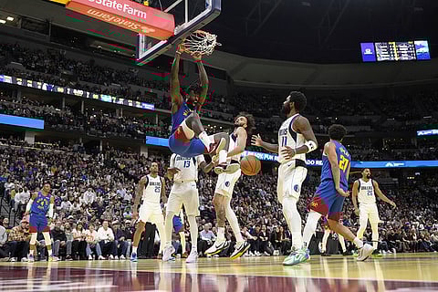 NBA 2024-25: Nuggets center DeAndre Jordan, top center left, dunks against the Mavericks
