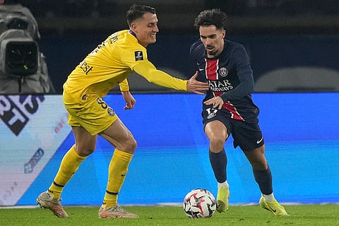 Ligue 1: Toulouse's Vincent Sierro, left, and PSG's Vitinha fight for the ball