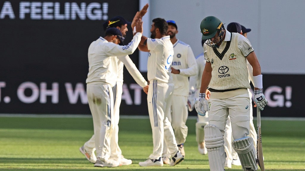 India celebrate the wicket of Australia captain Pat Cummins on the first day of the first Test in Perth. - AP/Trevor Collens