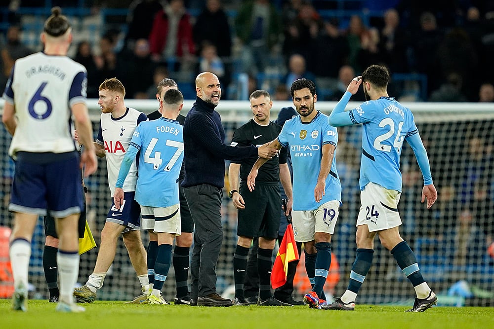 | Photo: AP/Dave Thompson : EPL 2024-25: Manchester City's head coach Pep Guardiola speaks with his players at the end of the match