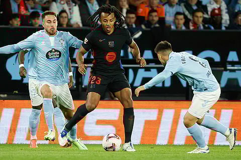 La Liga: Barcelona's Jules Kounde, center, competes for the ball against Celta's Oscar Mingueza, left, and Fran Beltran