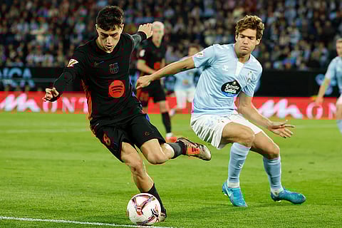 La Liga: Barcelona's Pedri, left, dribbles the ball past Celta's Marcos Alonso