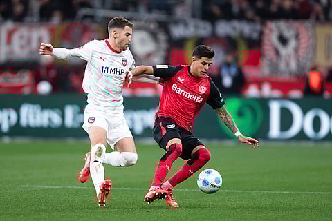 Bundesliga 2024-25: Leverkusen's Piero Hincapie, right, and Heidenheim's Marvin Pieringer, left, cahllenge for the ball