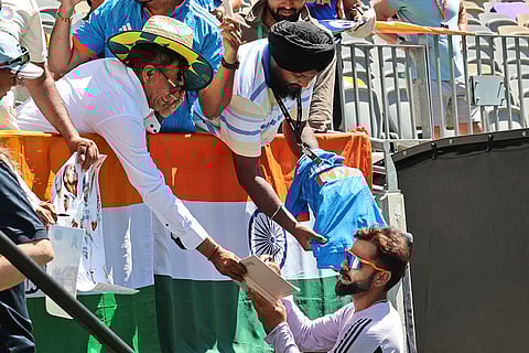 IND Vs AUS 1st Test, Day 3: India's Virat Kohli autographs a book for a fan before the start of play