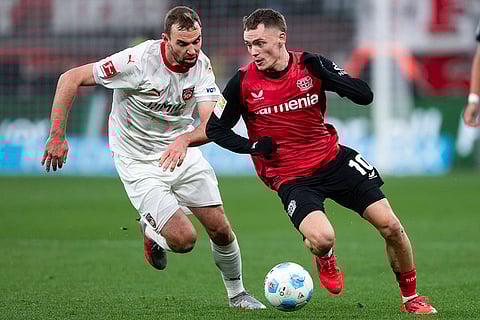Bundesliga 2024-25: Leverkusen's Florian Wirtz, right, and Heidenheim's Benedikt Gimber, left, callenge for the ball