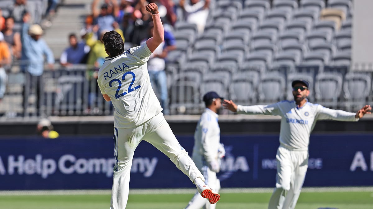 AP Photo/Trevor Collens : India's Harshit Rana, left, celebrates the wicket of Australia's Alex Carey on the fourth day of the first cricket test between Australia and India in Perth.