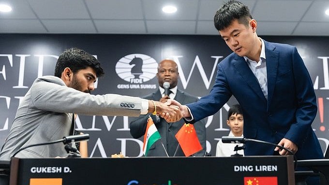 X/FIDE : Ding Liren and D Gukesh shake hands 