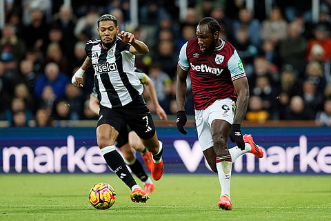 EPL 2024-25: West Ham United's Michail Antonio, right, and Newcastle United's Joelinton, left, challenge for the ball 