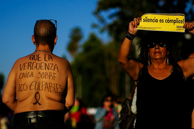 People perform during a march in Santiago, Chile - | Photo: AP/Esteban Felix