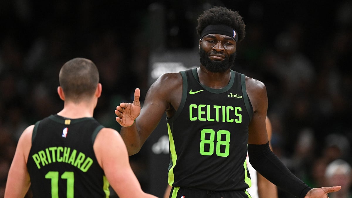 Payton Pritchard and Neemias Queta of the Boston Celtics celebrate against the Los Angeles Clippers on Nov. 25, 2024. - null