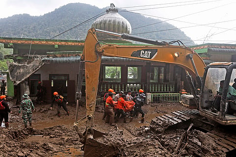 Indonesia Flash Floods: Rescuers carry the body of a victim