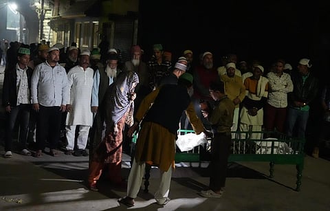 Hanif and his relatives at Abbasi wala Mauhalla with the dead body of his son Ayaan who was shot on Sunday during the clashes between the police and locals.