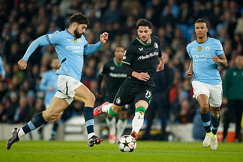 UEFA Champions League: Feyenoord's Julian Carranza, center, challenges Manchester City's Josko Gvardiol