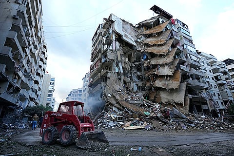 Middle East Tensions: A civil defence worker in Lebanon clears debris