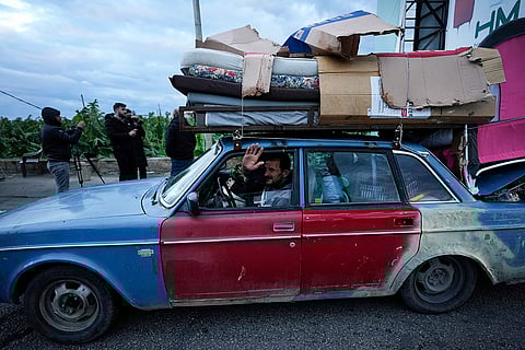 Israel Lebanon Ceasefire: A man waving as he heads back to his village