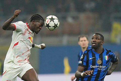 UEFA Champions League: Leipzig's Castello Lukeba makes a header next to Inter Milan's Marcus Thuram