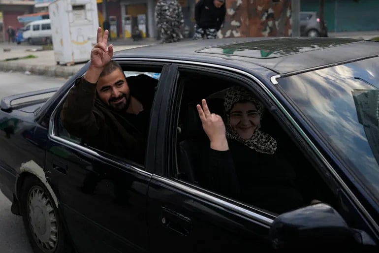 AP : People flash victory signs as they return back to their villages after a ceasefire between Hezbollah and Israel |