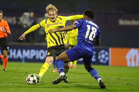 Champions League 2024-25: Dortmund's Julian Brandt, left, is challenged by Dinamo's Ronael Pierre-Gabriel