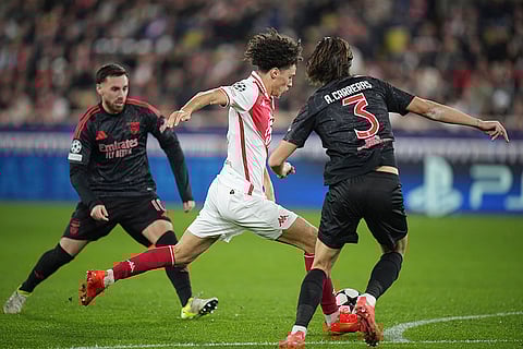 Champions League 2024-25: Monaco's Maghnes Akliouche, center, and Benfica's Alvaro Carreras fight for the ball