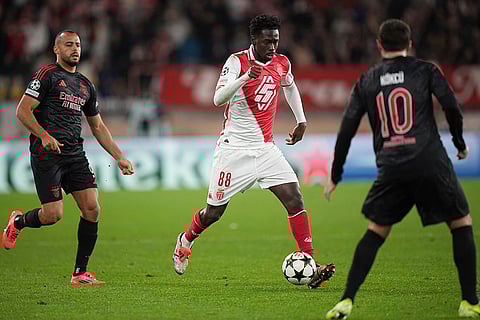 Champions League 2024-25: Monaco's Soungoutou Magassa, center, controls a ball chased by Benfica's Arthur Cabral