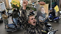 Hezbollah Warns Israel as Fragile Lebanon Truce Holds | Photo: AP/Bilal Hussein : Israel Lebanon Ceasefire: A man celebrates carrying a picture of slain Hezbollah leader Hassan Nasrallah
