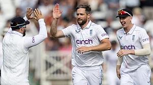 File : Chris Woakes took two consecutive wickets in Christchurch to put England on the brink of victory